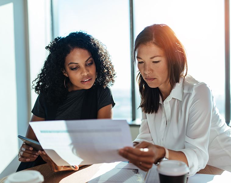 Two women looking at paperwork