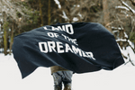 A person with a "Land of the Dreamer" flag